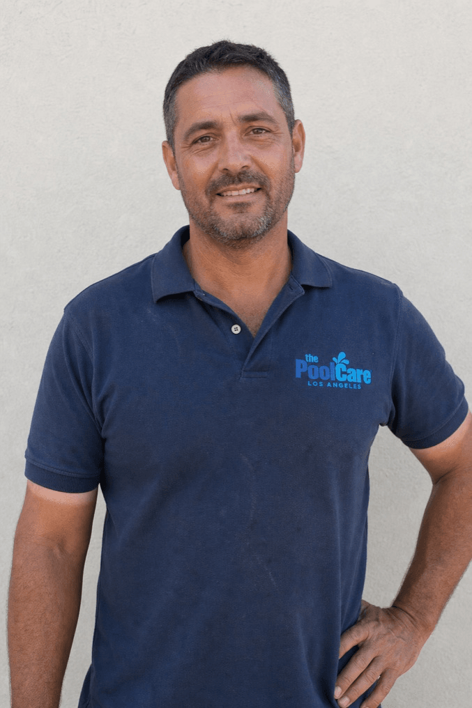 The owner of Pool Care LA in a branded polo