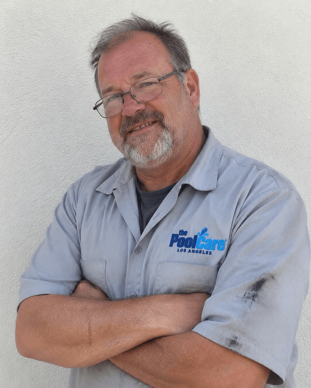 A Pool Care LA repair technician in a branded polo